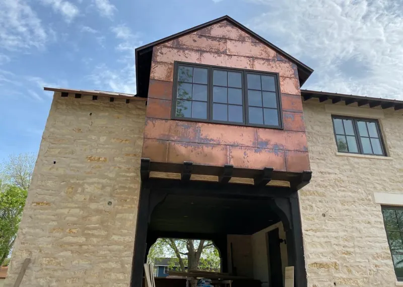 Copper metal panel facade on a stone building for Metal Roof Coating in Euless