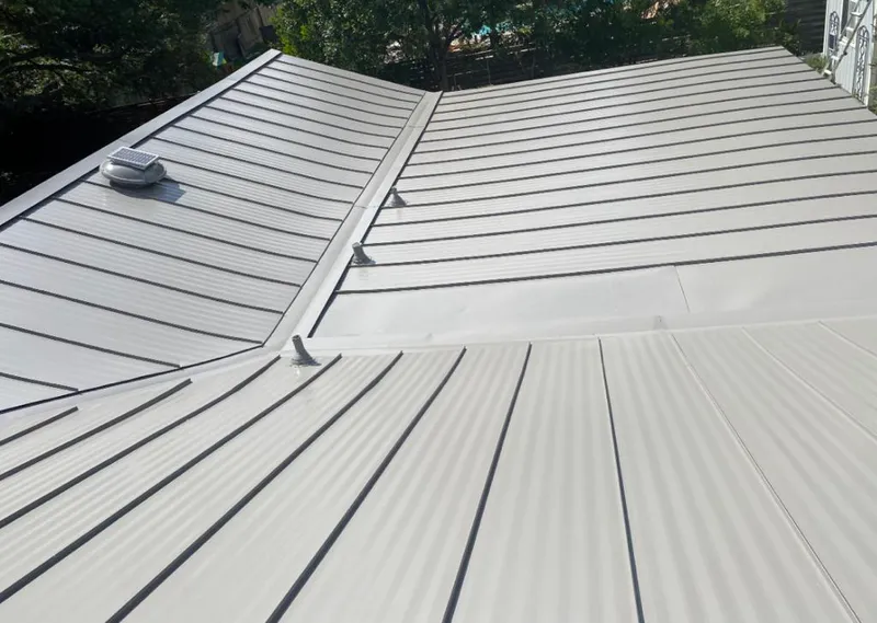 Solar attic fan installed on a metal roof for Roof Ventilation in Euless